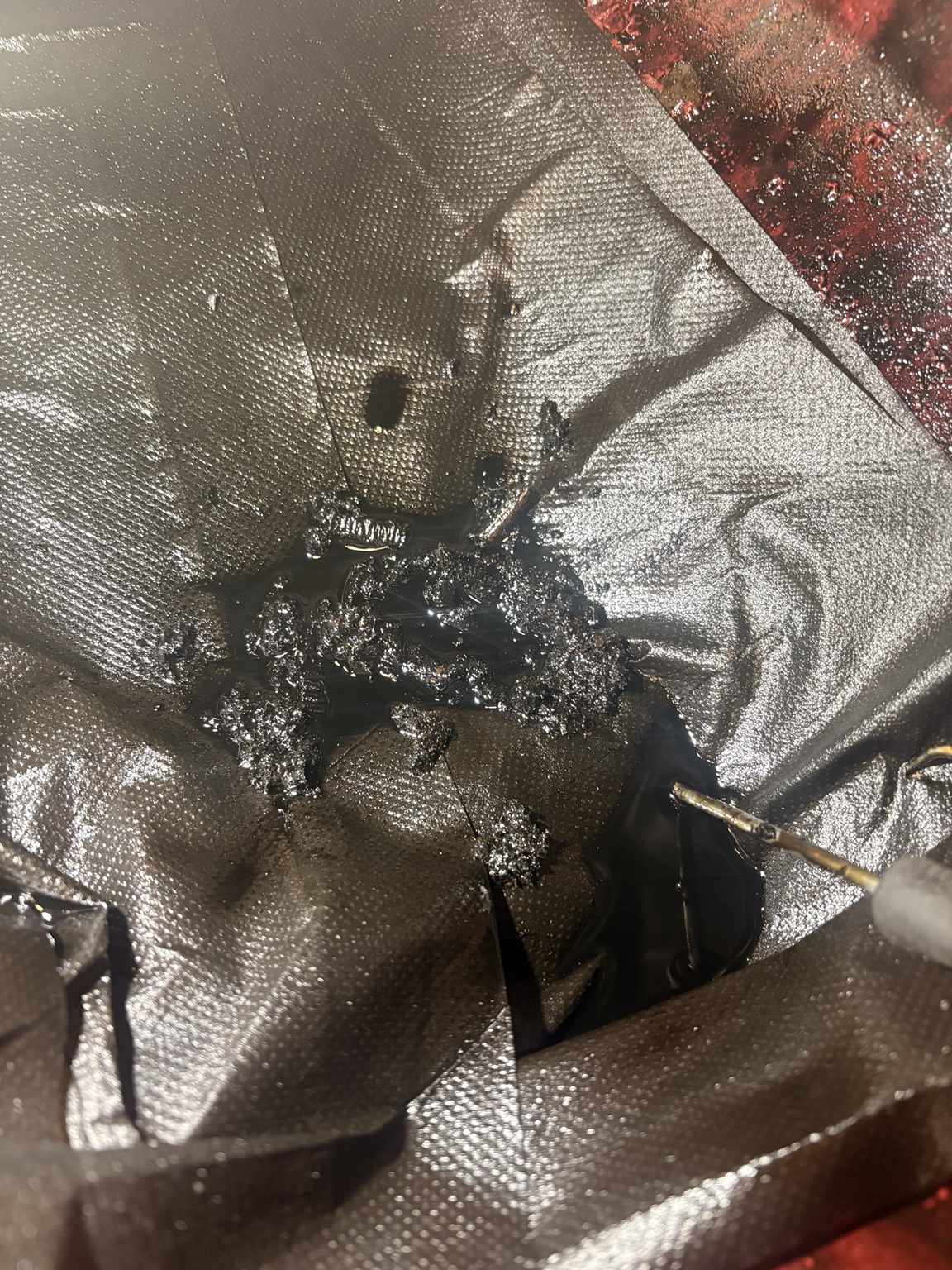 Fragments of degraded wet timing belt removed during repair